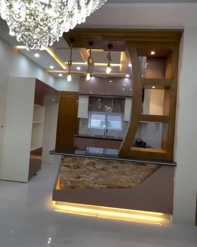 Cocina con barra iluminada, entrepaños curvos y luces LED en el techo, en Anapoima